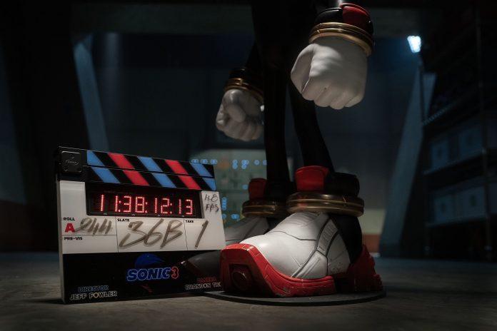 Image showing a filming clapboard on the ground, near the boot/shoe of Shadow the Hedgehog